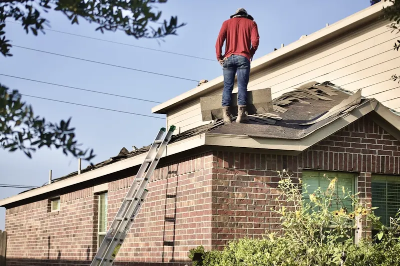 Professional roofer working on a residential roof in West Moorestown